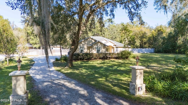 view of front of house featuring a front lawn and fence