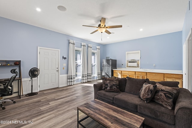 living room featuring a ceiling fan, a wainscoted wall, wood finished floors, cooling unit, and recessed lighting