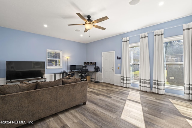 living area with a wainscoted wall, ceiling fan, wood finished floors, and recessed lighting