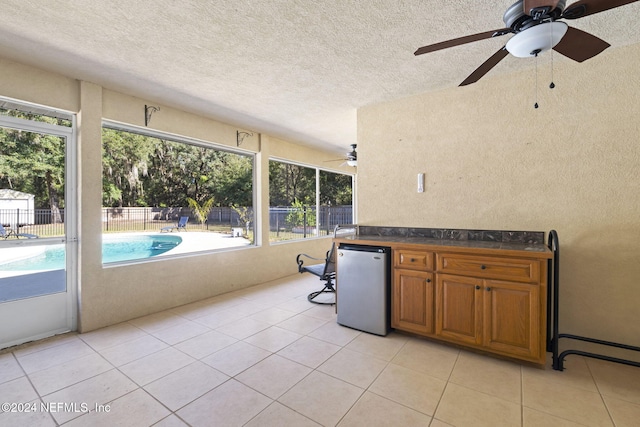 sunroom / solarium featuring ceiling fan