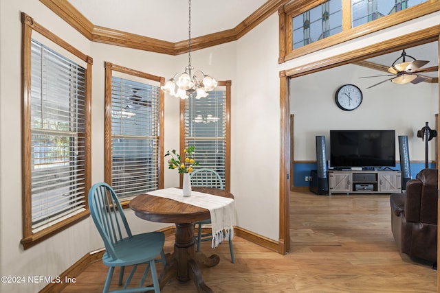 dining room with crown molding, light hardwood / wood-style flooring, and ceiling fan with notable chandelier