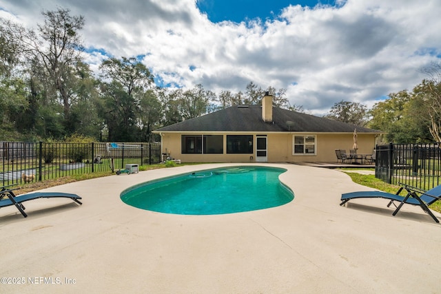 view of pool featuring a patio area, fence, and a fenced in pool