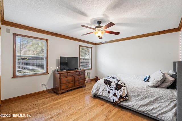 bedroom with light wood-type flooring, multiple windows, ornamental molding, and a textured ceiling