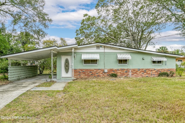 ranch-style house with a front lawn and a carport