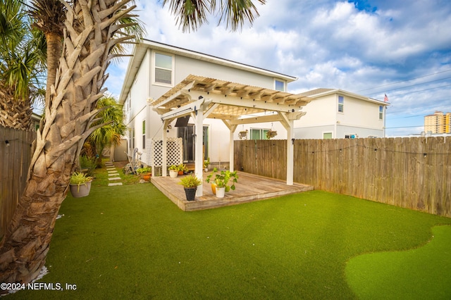 back of house with a yard, a pergola, and a deck