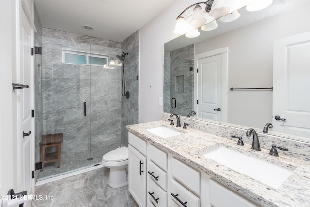 bathroom with vanity, an enclosed shower, a textured ceiling, and toilet