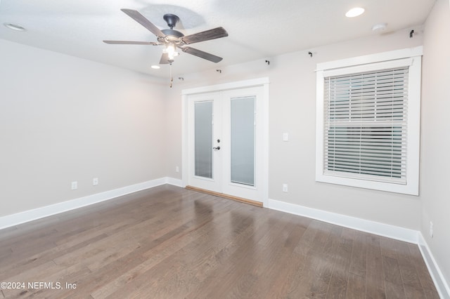 empty room featuring dark wood-type flooring, french doors, and ceiling fan