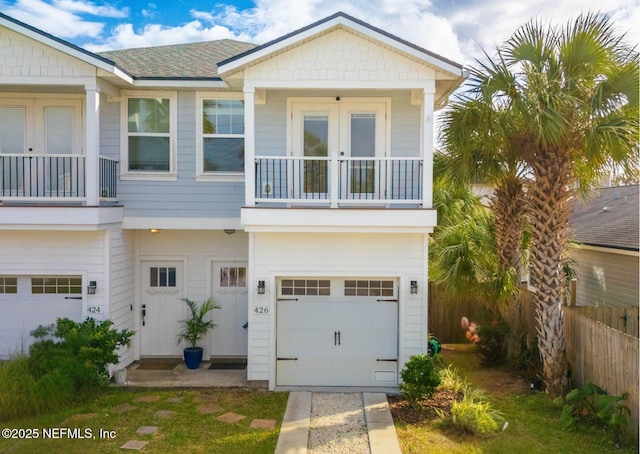 view of front of house with a garage and a balcony