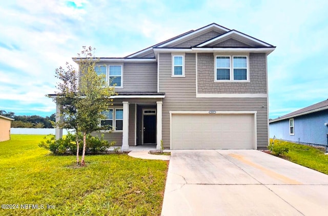 view of front of property with a front yard and a garage