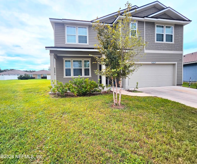 view of front of property featuring a front yard and a garage