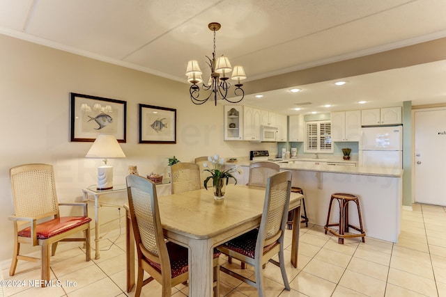 3350 S Fletcher Ave Unit J1, Fernandina Beach, FL 32034 - dining area with light tile patterned floors, ornamental molding, and a notable chandelier