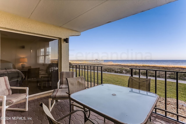 3350 S Fletcher Ave Unit J1, Fernandina Beach, FL 32034 - balcony featuring a beach view, outdoor dining area, and a water view