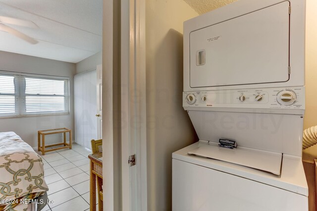 3350 S Fletcher Ave Unit J1, Fernandina Beach, FL 32034 - washroom featuring light tile patterned floors, stacked washer and dryer, laundry area, and a ceiling fan