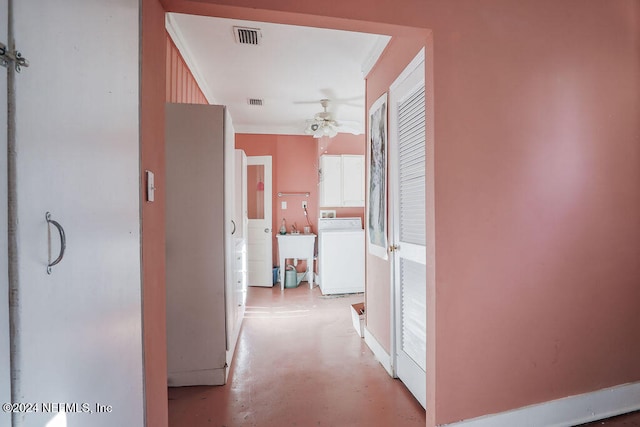 hall with crown molding and washer / clothes dryer