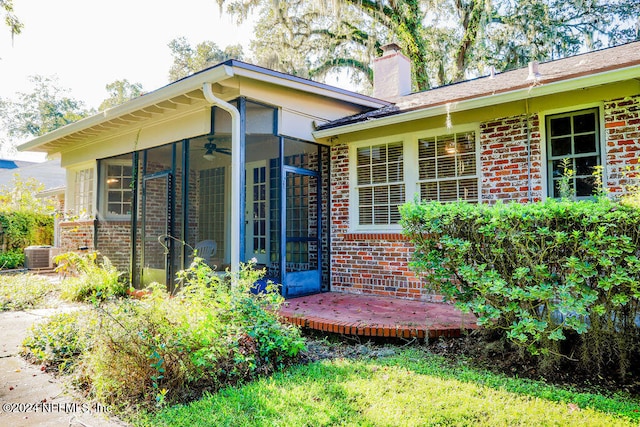 exterior space featuring central AC and a sunroom