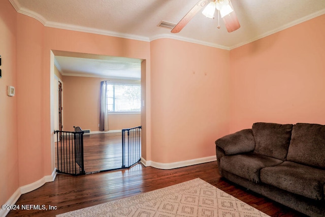 living room featuring crown molding, dark hardwood / wood-style floors, and ceiling fan