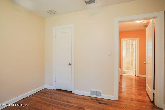 empty room with dark wood-type flooring