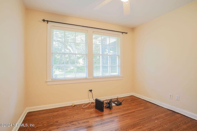 spare room featuring wood-type flooring and ceiling fan