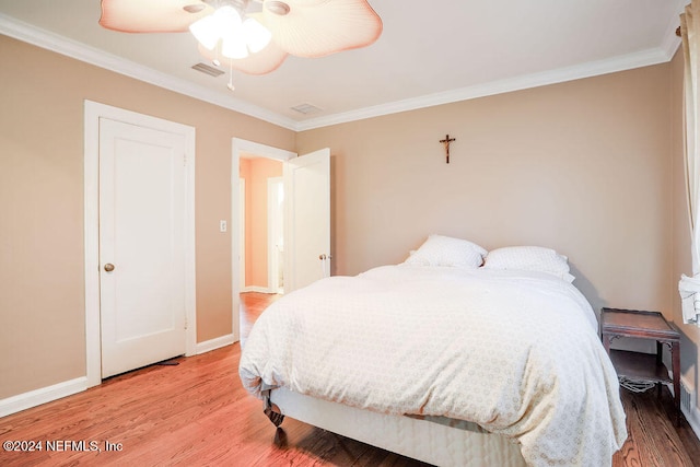 bedroom with ceiling fan, hardwood / wood-style flooring, and ornamental molding