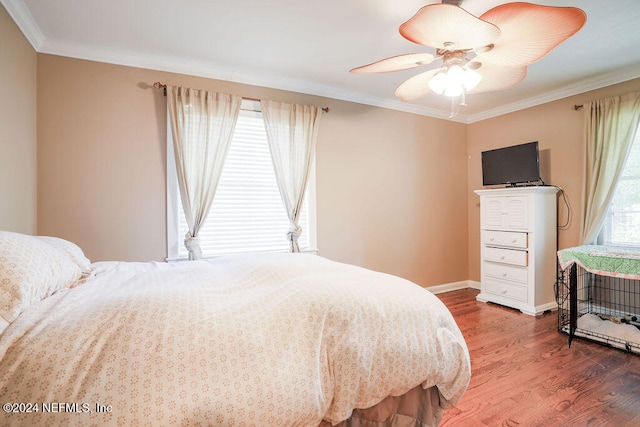 bedroom featuring ornamental molding, multiple windows, dark hardwood / wood-style floors, and ceiling fan