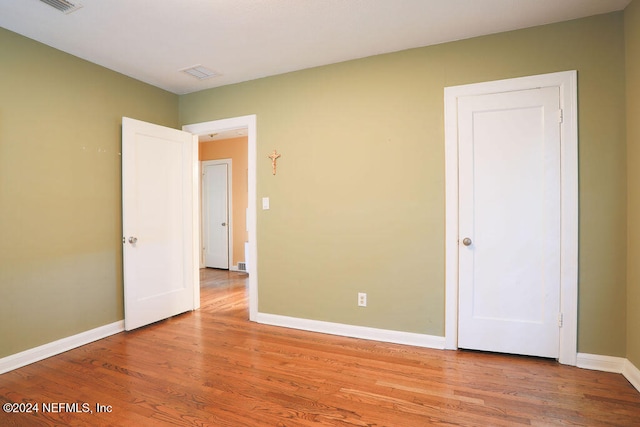 unfurnished bedroom with wood-type flooring