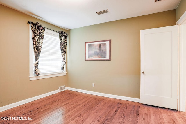 unfurnished room with light wood-type flooring