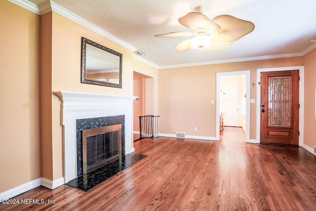 unfurnished living room with a high end fireplace, crown molding, hardwood / wood-style flooring, and a textured ceiling