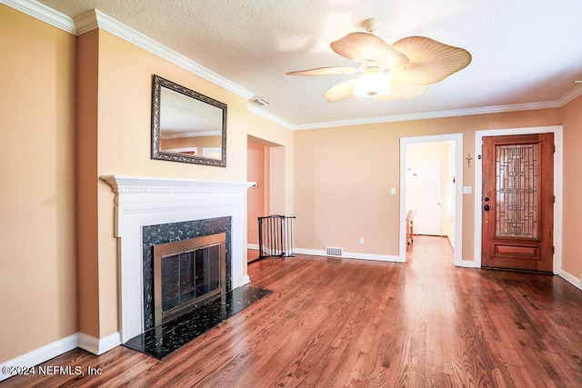 unfurnished living room with a high end fireplace, a textured ceiling, crown molding, and hardwood / wood-style flooring