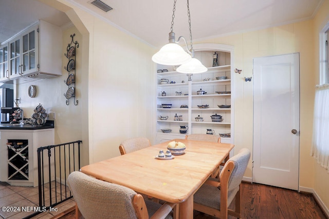 dining space featuring crown molding and dark hardwood / wood-style floors