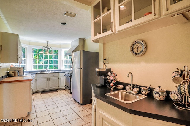 kitchen with appliances with stainless steel finishes, extractor fan, ornamental molding, light tile patterned flooring, and sink