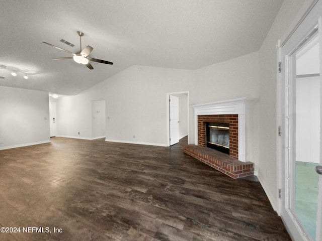 unfurnished living room with lofted ceiling, a brick fireplace, dark hardwood / wood-style floors, and ceiling fan