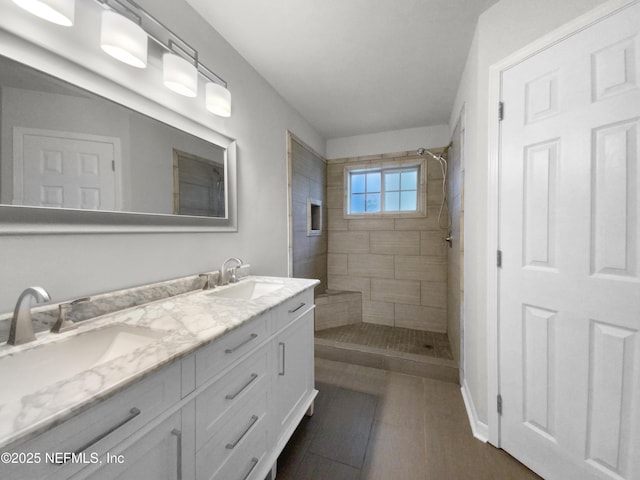 bathroom featuring vanity and tiled shower