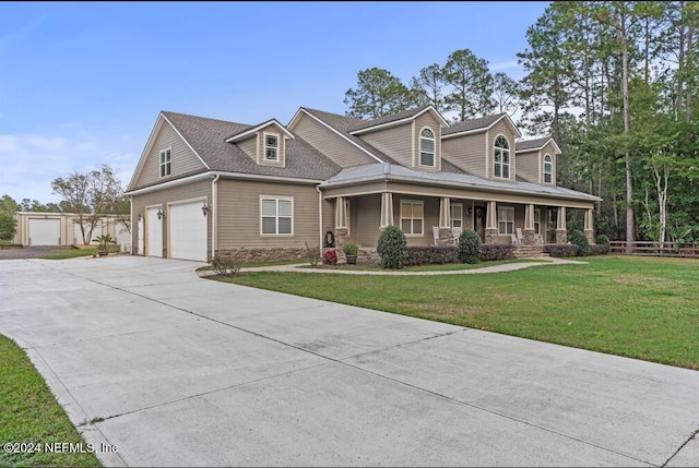 view of front of house with covered porch, a garage, and a front yard