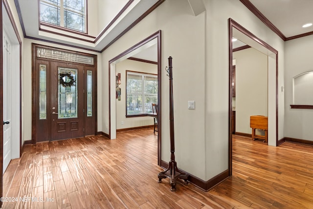 entrance foyer featuring hardwood / wood-style floors and crown molding