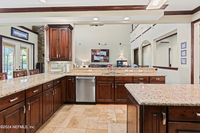 kitchen featuring french doors, sink, dark brown cabinets, kitchen peninsula, and a breakfast bar area