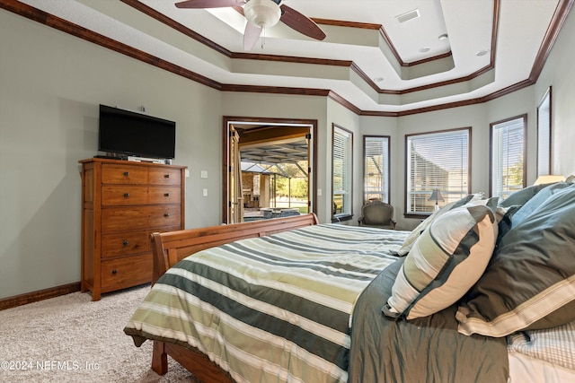 carpeted bedroom featuring a tray ceiling, access to exterior, ceiling fan, and ornamental molding