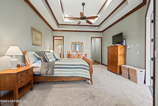 bedroom featuring light colored carpet, a raised ceiling, ceiling fan, and crown molding