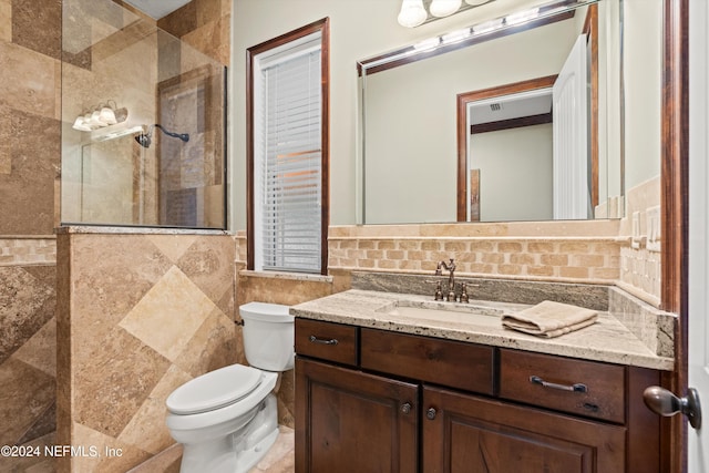 bathroom with vanity and tile walls