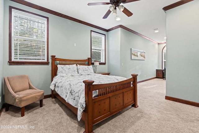 bedroom featuring ceiling fan, crown molding, and light carpet