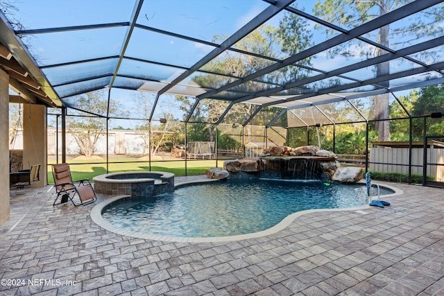 view of swimming pool with pool water feature, a patio, and a lanai