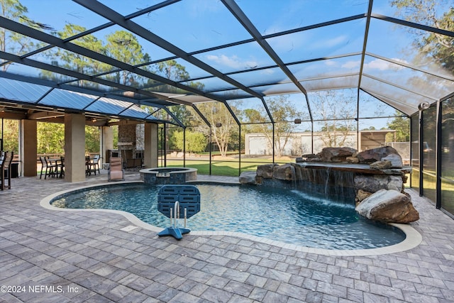 view of swimming pool with glass enclosure, pool water feature, an in ground hot tub, a bar, and a patio