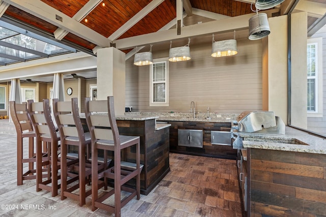 view of patio featuring an outdoor wet bar and an outdoor kitchen