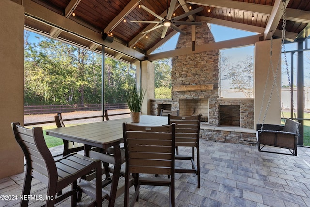 view of patio / terrace featuring ceiling fan and an outdoor stone fireplace