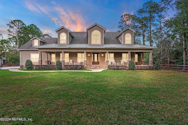 view of front of house featuring a porch and a lawn