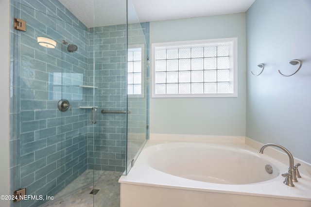 bathroom featuring independent shower and bath