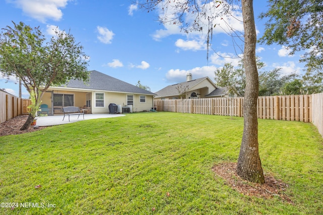 view of yard featuring central AC, a patio area, and a sunroom