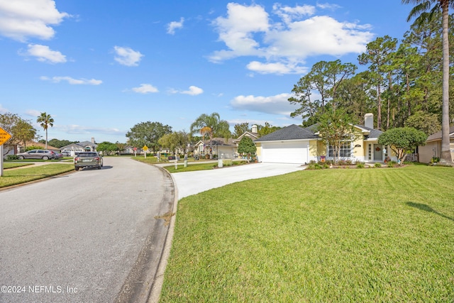 view of front of property with a garage and a front yard