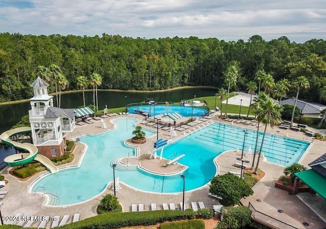 view of swimming pool with a water view, a water slide, and a patio