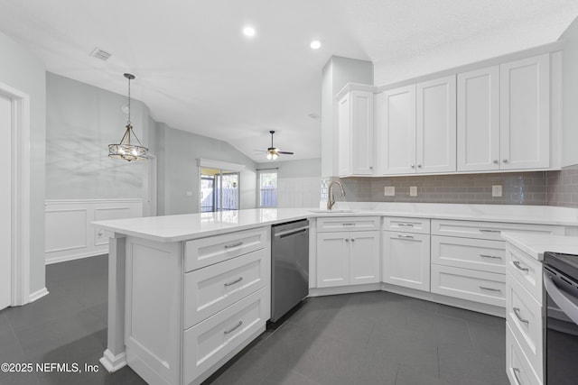 kitchen with ceiling fan with notable chandelier, pendant lighting, white cabinetry, kitchen peninsula, and stainless steel dishwasher