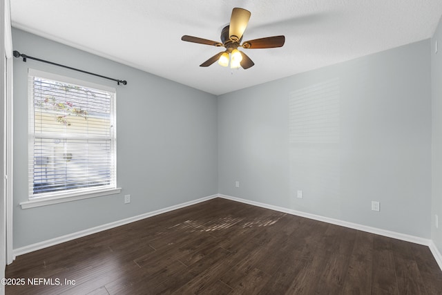 spare room with ceiling fan and dark hardwood / wood-style floors